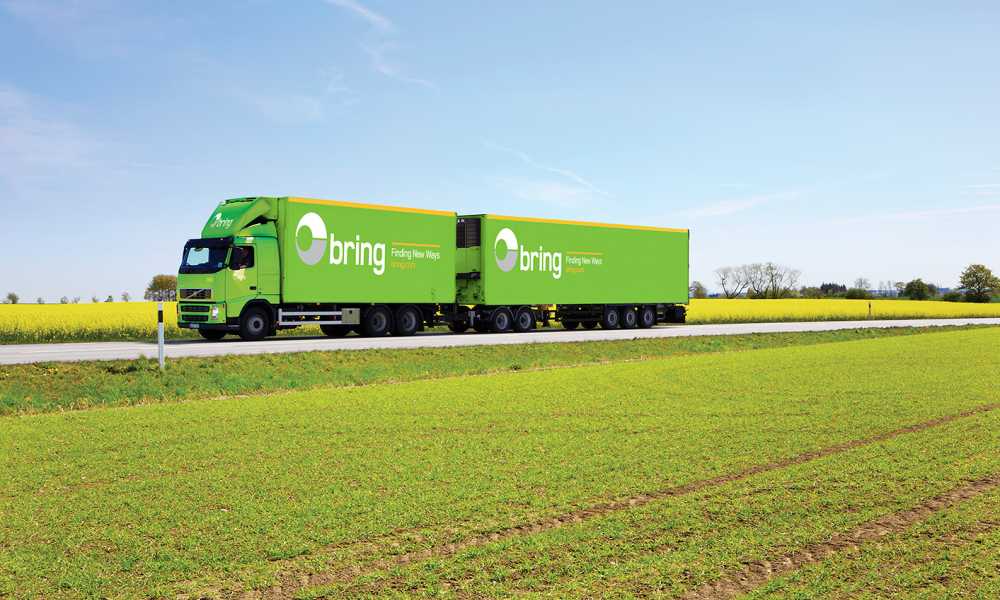 A Bring freight truck on road in field