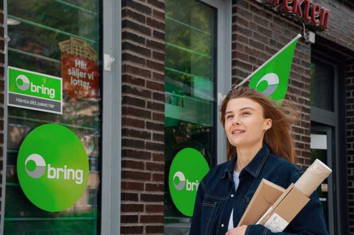 Kvinna med paket utanför paketombud