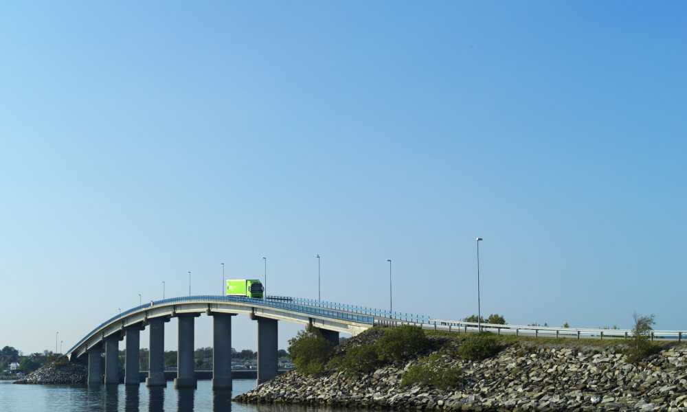 A Bring truck is driving on a bridge