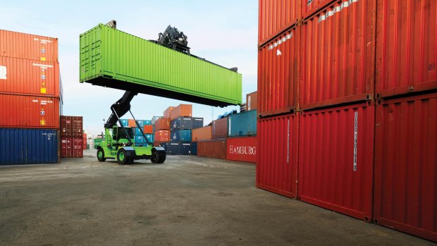 A Bring truck lifts a green container.