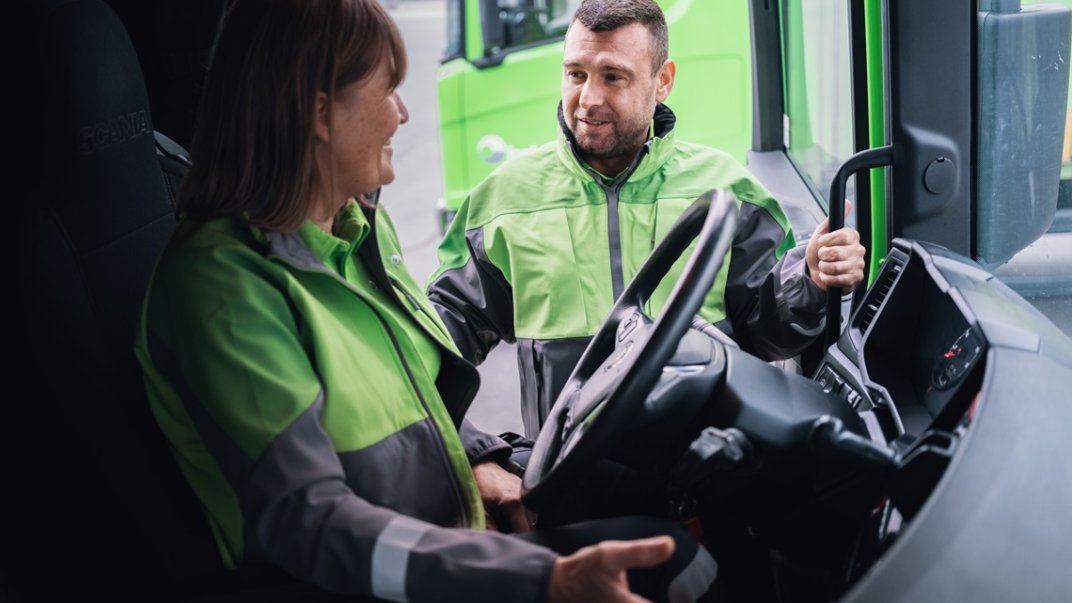 Bring driver in a truck talking to other Bring employee outside