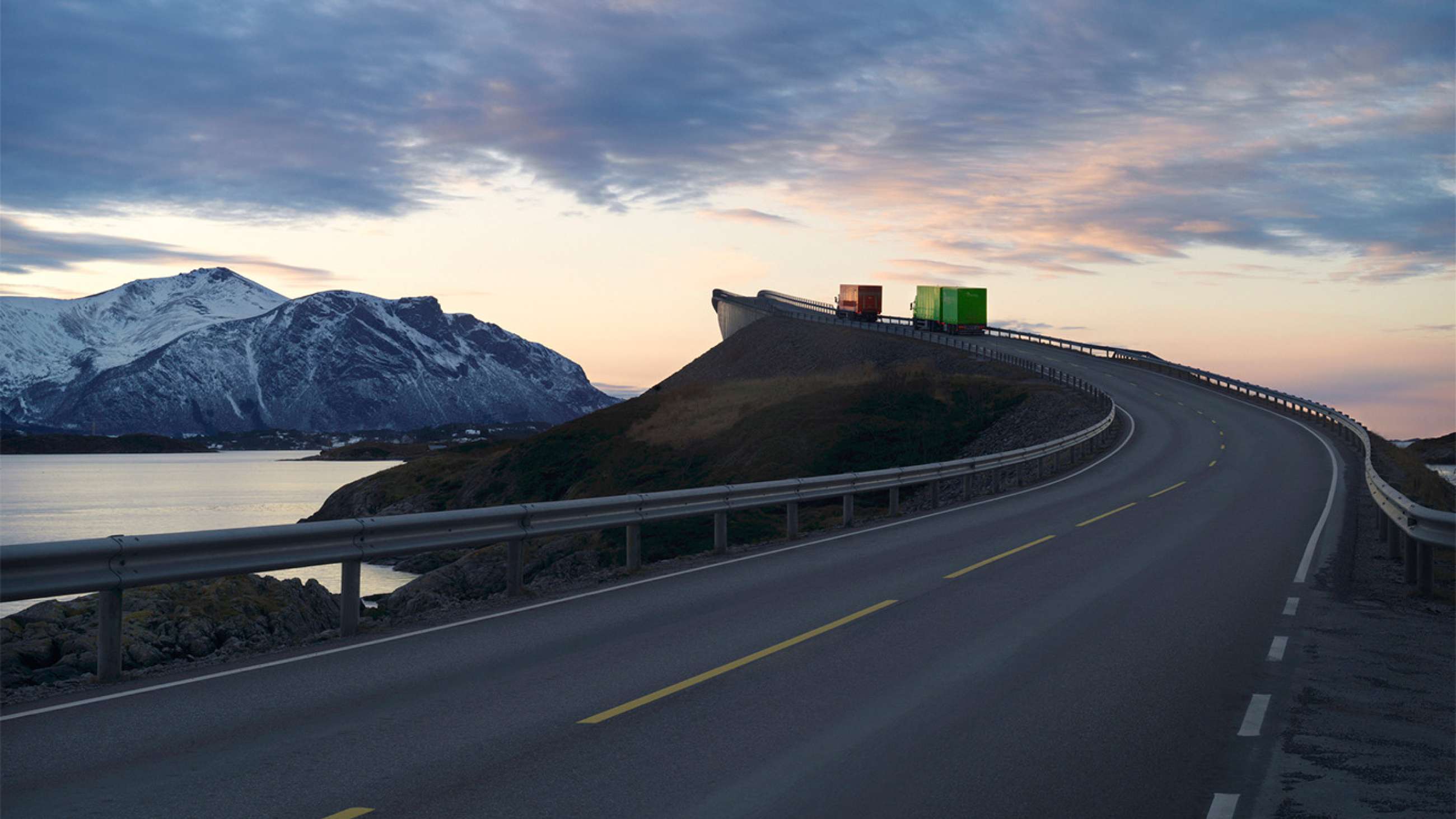 Two trucks driving on the Atlantic Ocean Road in Norway
